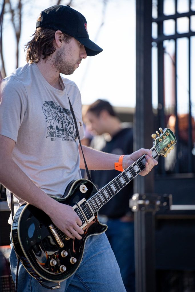 A guitar player entertains fans in the concourse before a One Knoxville match