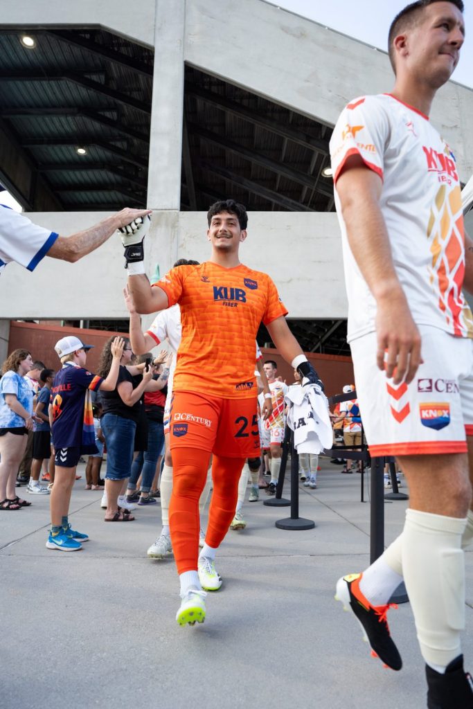 One Knoxville players give high fives before walking out onto the pitch for a match